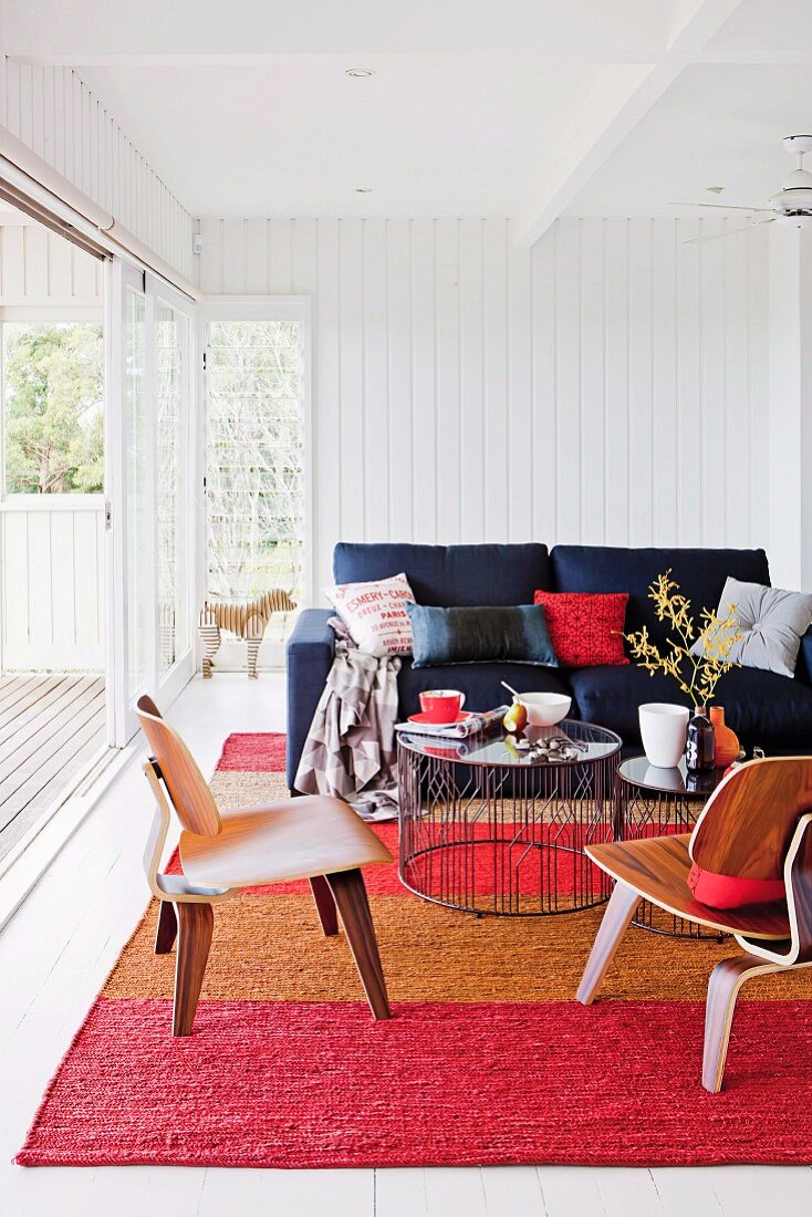 Cozy lounge area on striped carpet in front of an open sliding patio door