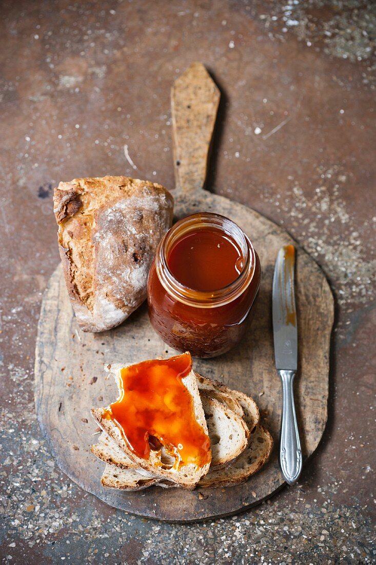 Haw berry jam and bread on a chopping board