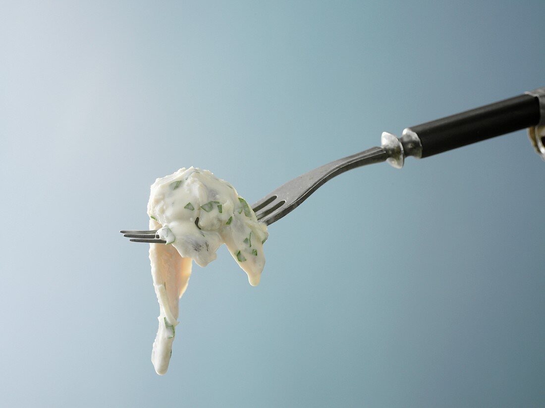 Fillet of herring with horseradish sauce on a fork