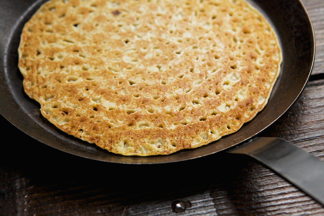 A pancake in a frying pan