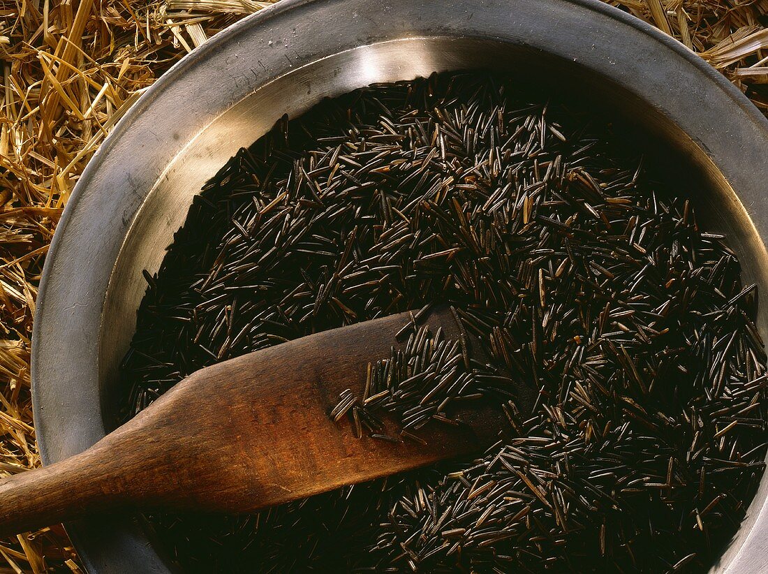 Wild Rice in a Metal Bowl with a Wooden Spoon