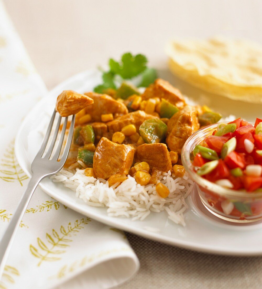 Chicken curry with sweetcorn and peppers on a bed of rice