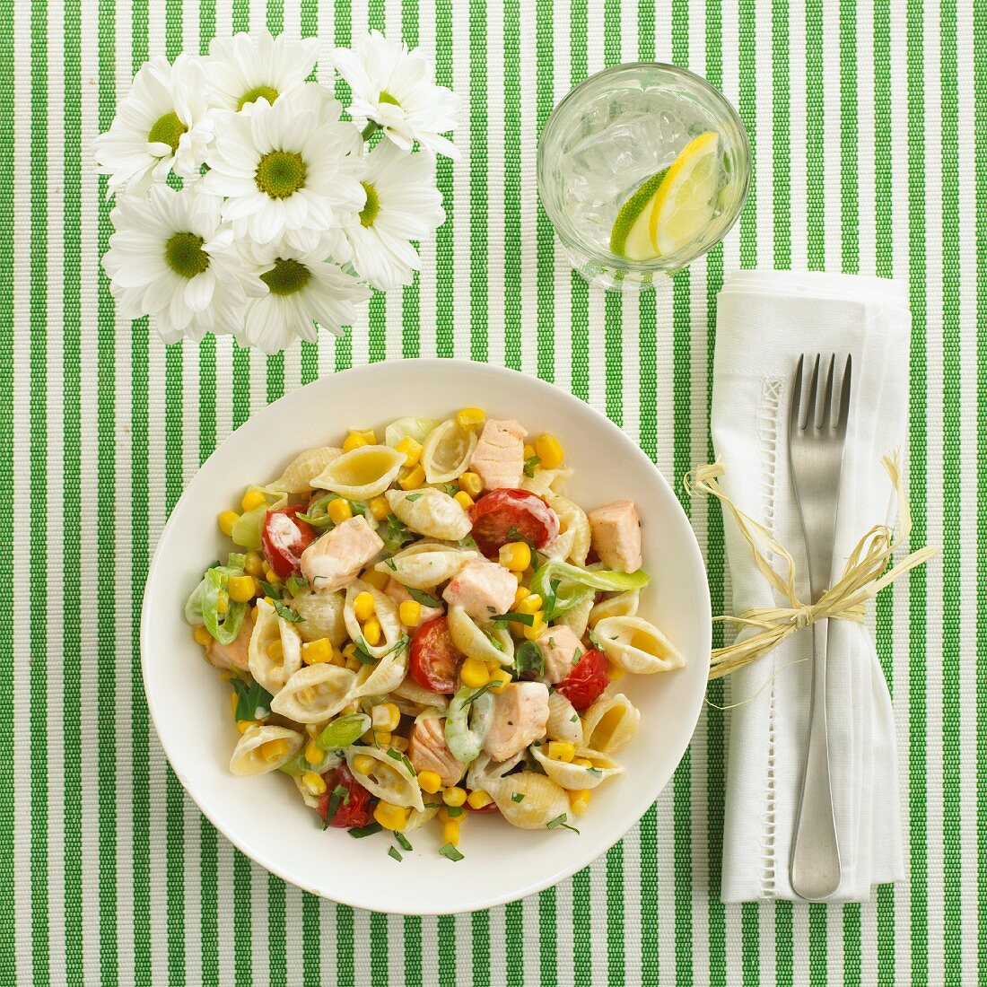 Pasta salad with pasta shells, salmon and vegetables (view from above)