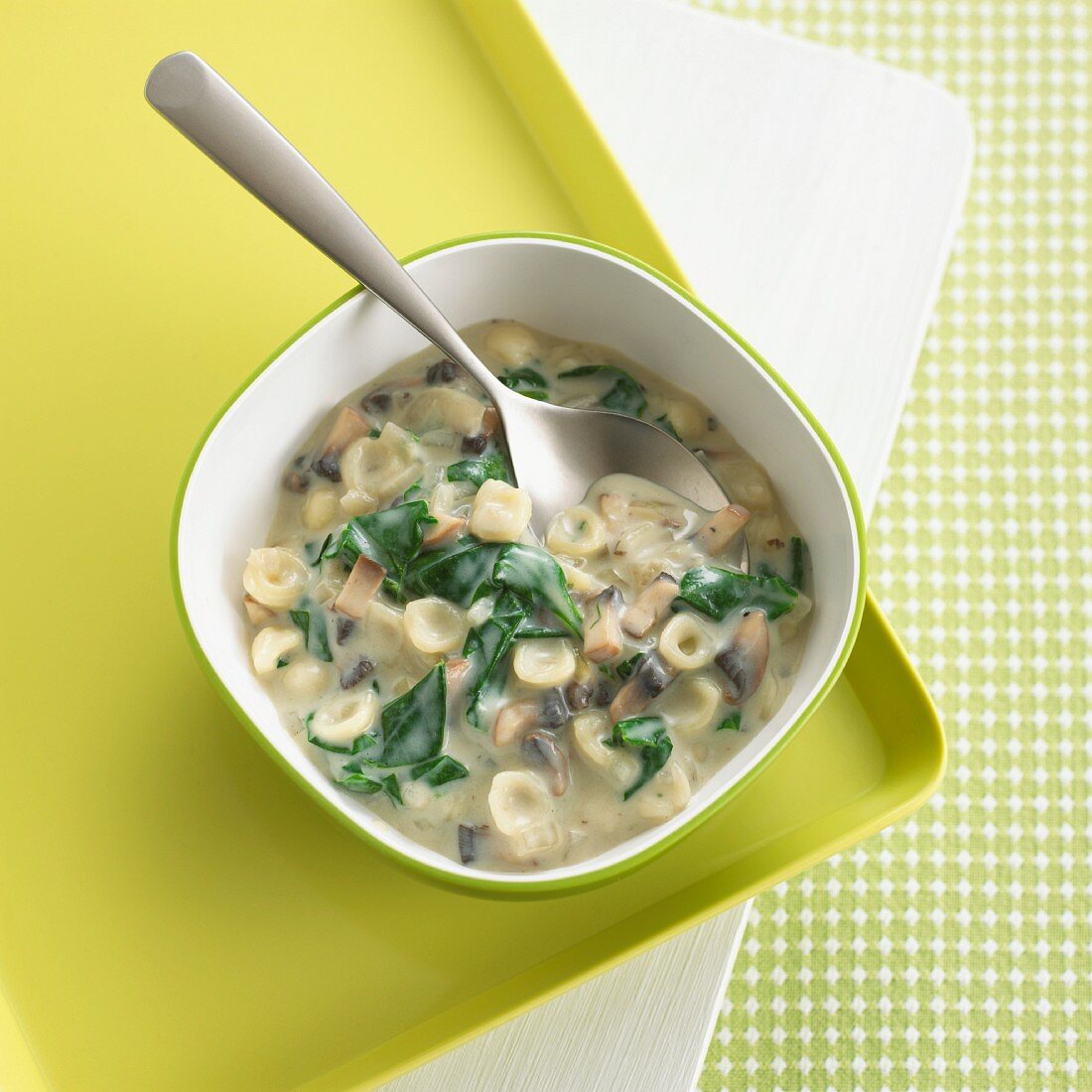 Pasta shells with spinach and mushrooms in a creamy sauce