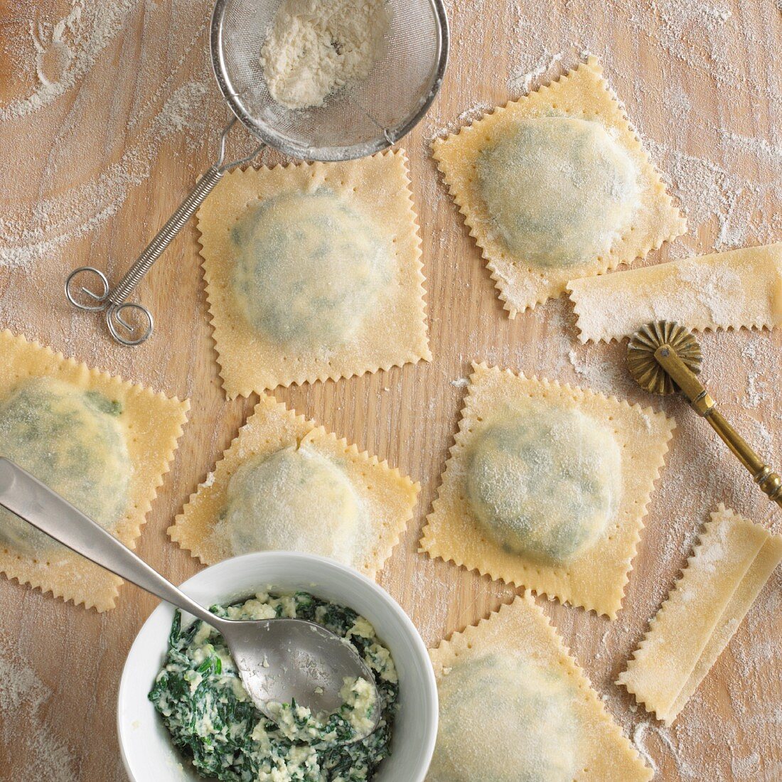 Making ravioli with spinach and ricotta filling