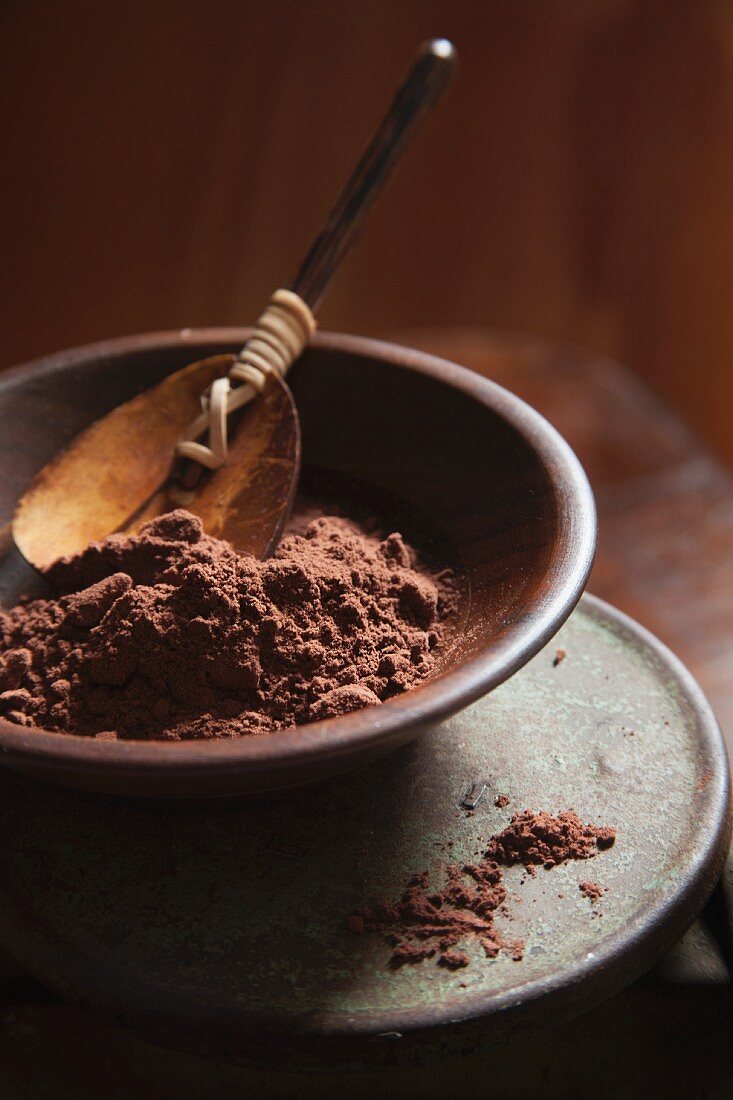 Coco Powder in a Brown Bowl with Wood Spoon