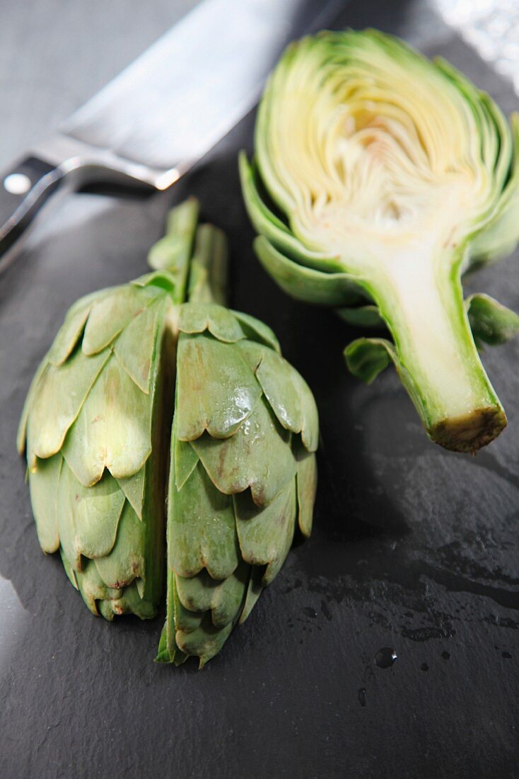 Still life of chopped artichokes on a slate cutting board