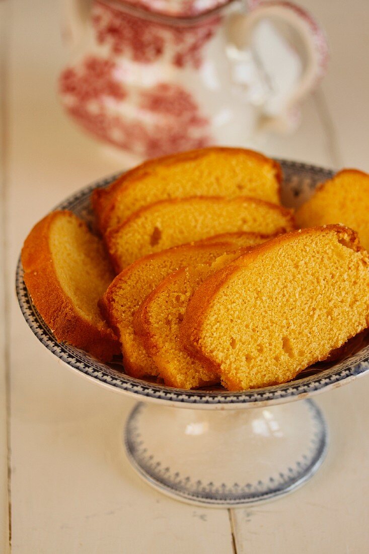 Lemon sponge cake, sliced, on a cake stand