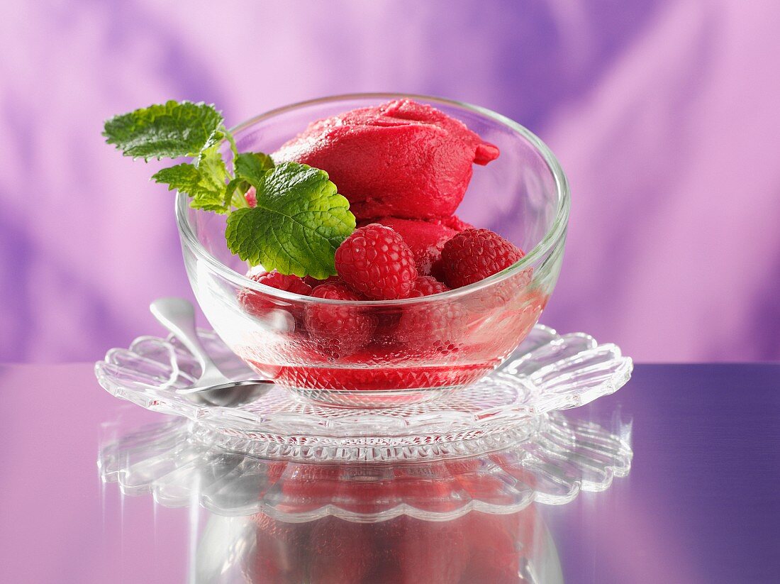 Raspberry ice cream with fresh raspberries and mint