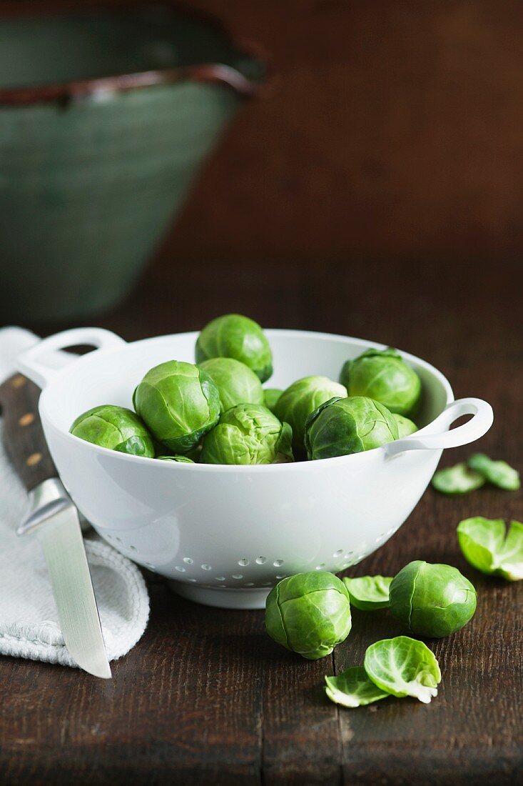 Brussels sprouts in a porcelain colander