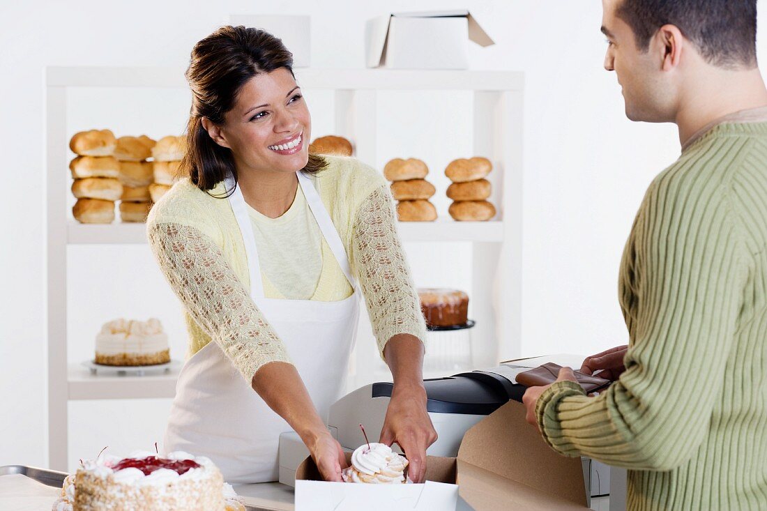 Woman at bakery helping customer