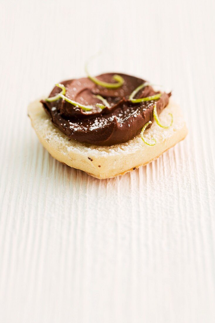 Bread roll topped with chocolate & coconut spread and lime zest