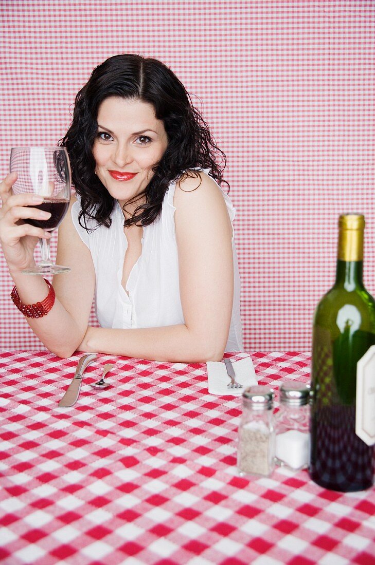 Portrait of woman in restaurant drinking wine