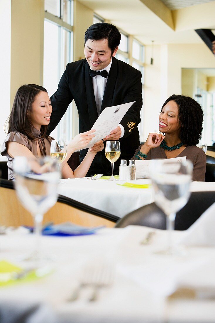 Businesswoman ordering meal in restaurant