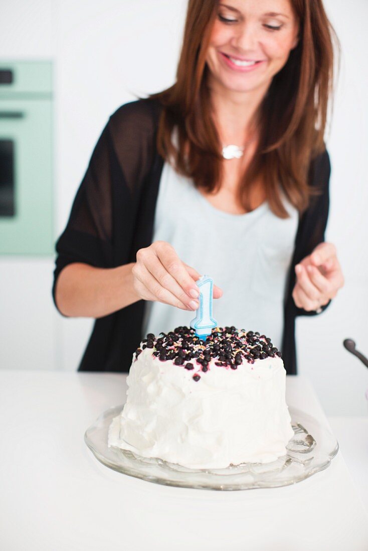 Woman preparing birthday cake