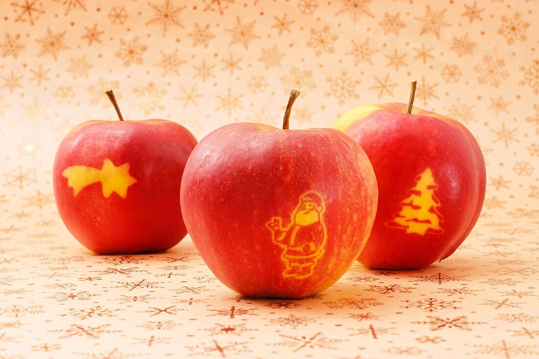 Three red apples with Christmas decoration
