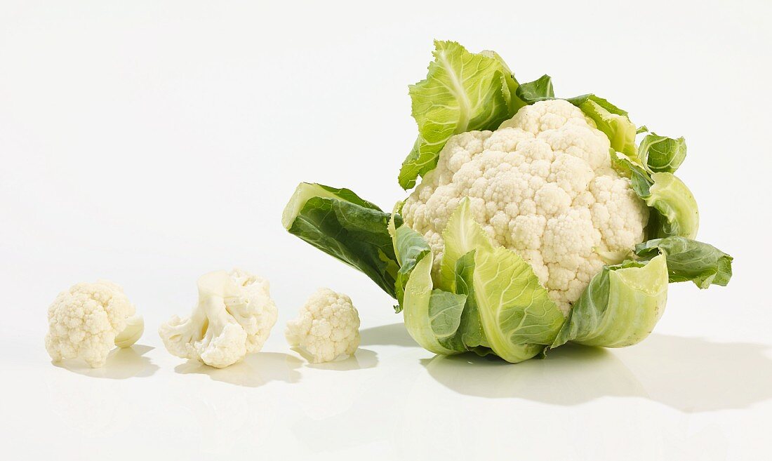 A whole cauliflower and florets