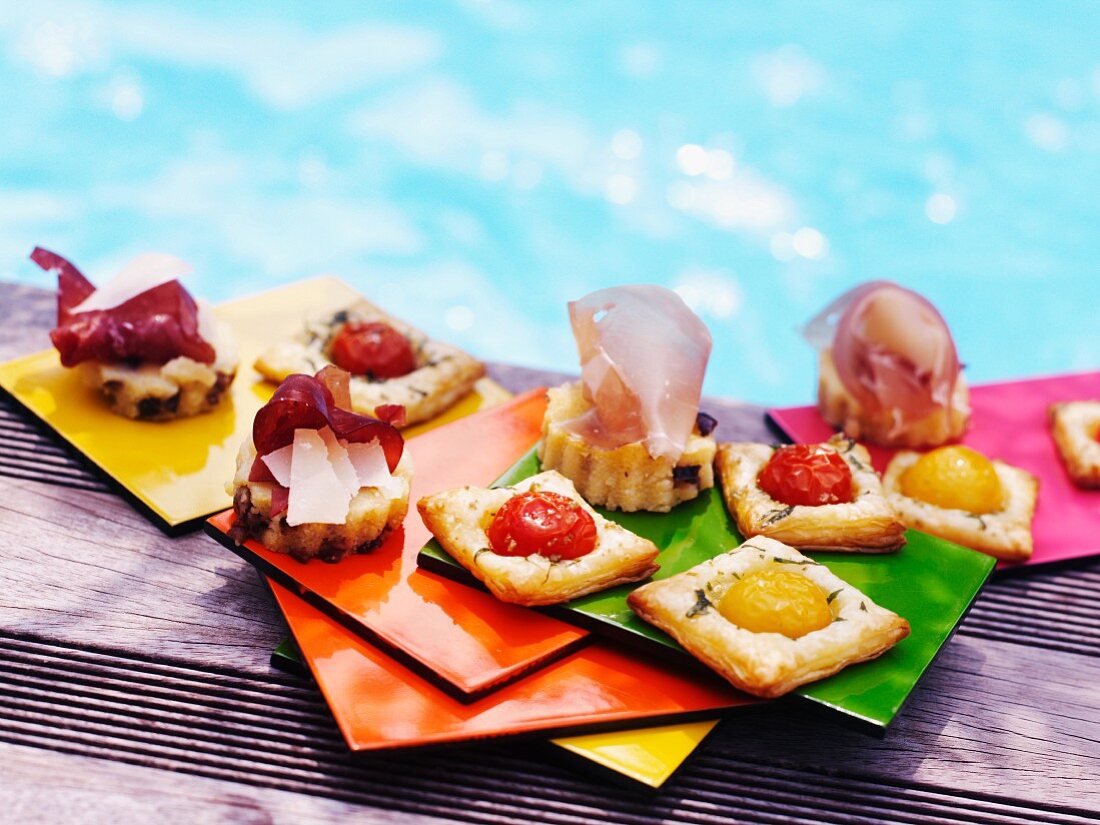 Assorted tartines on the edge of a swimming pool