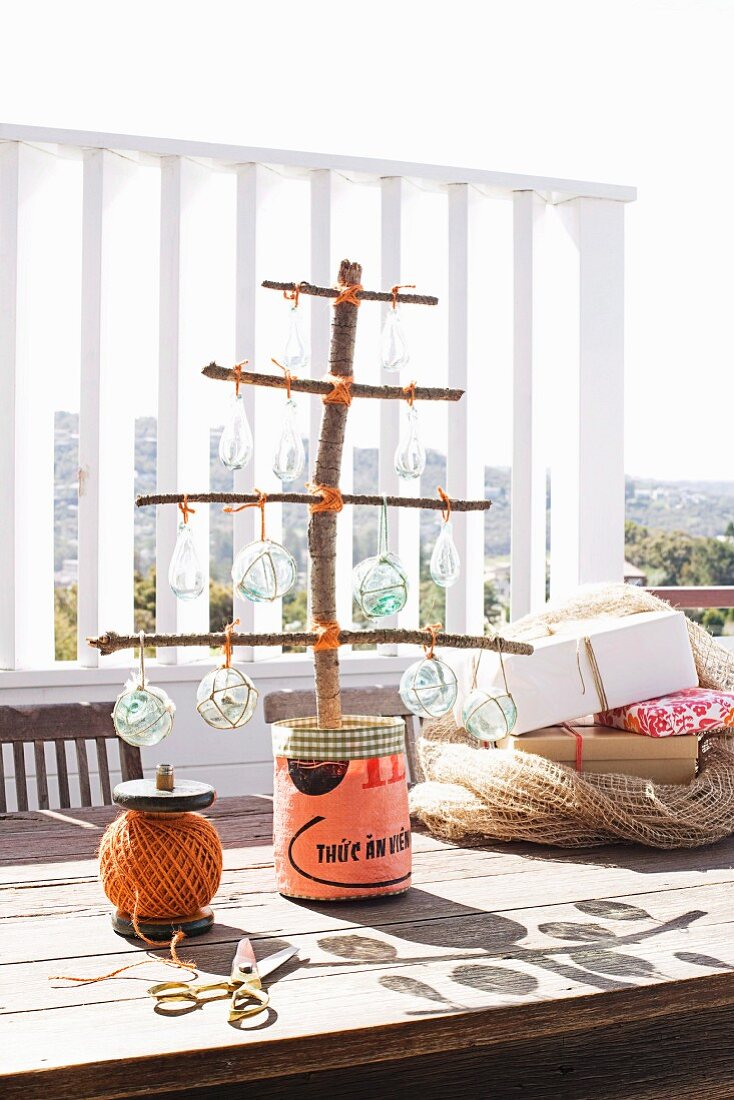 Stylized Christmas tree made from branches on a sunny terrace