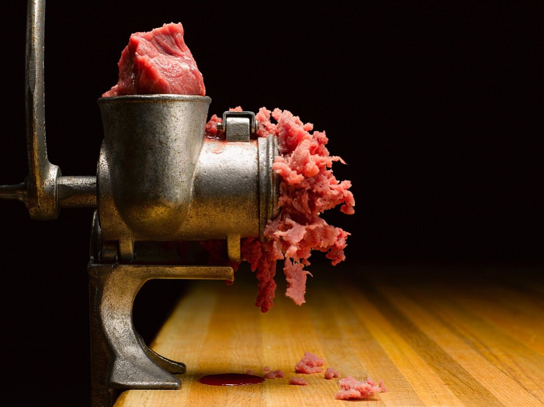 Metal Meat Grinder and Wooden Table