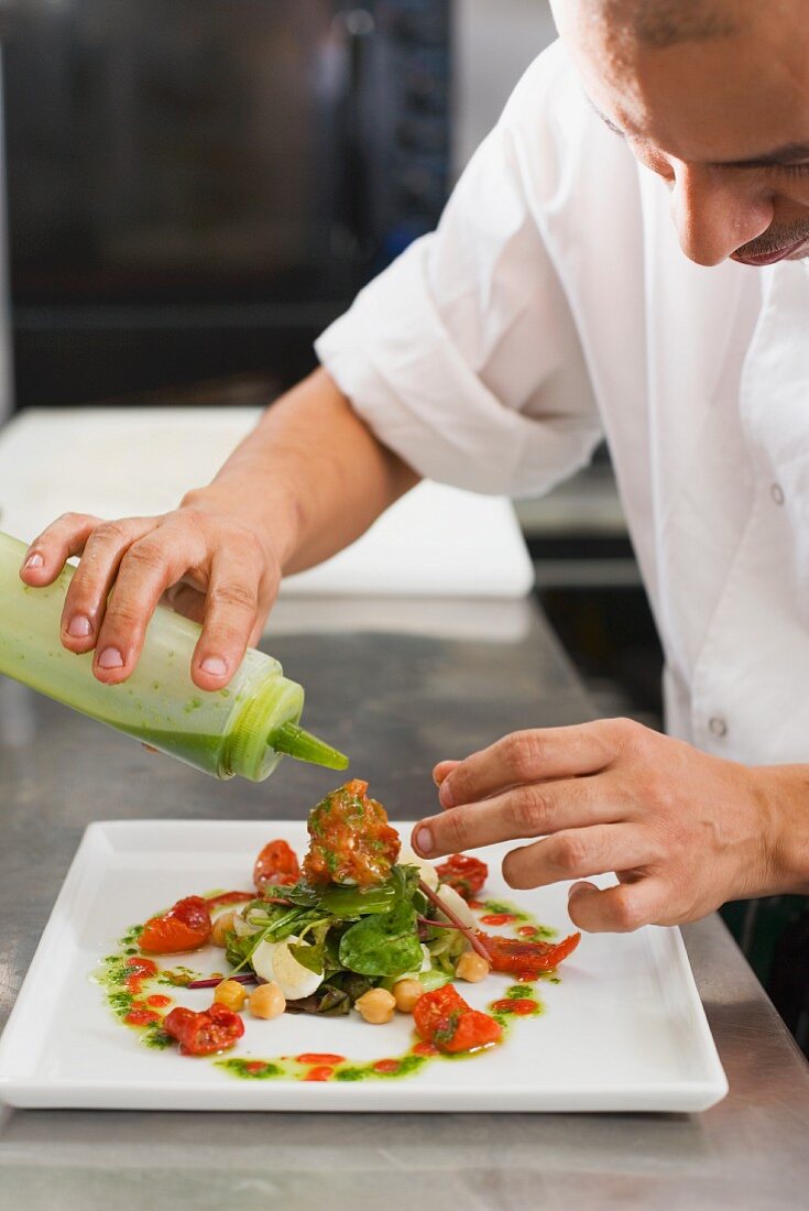 Male chef preparing meal in commercial kitchen