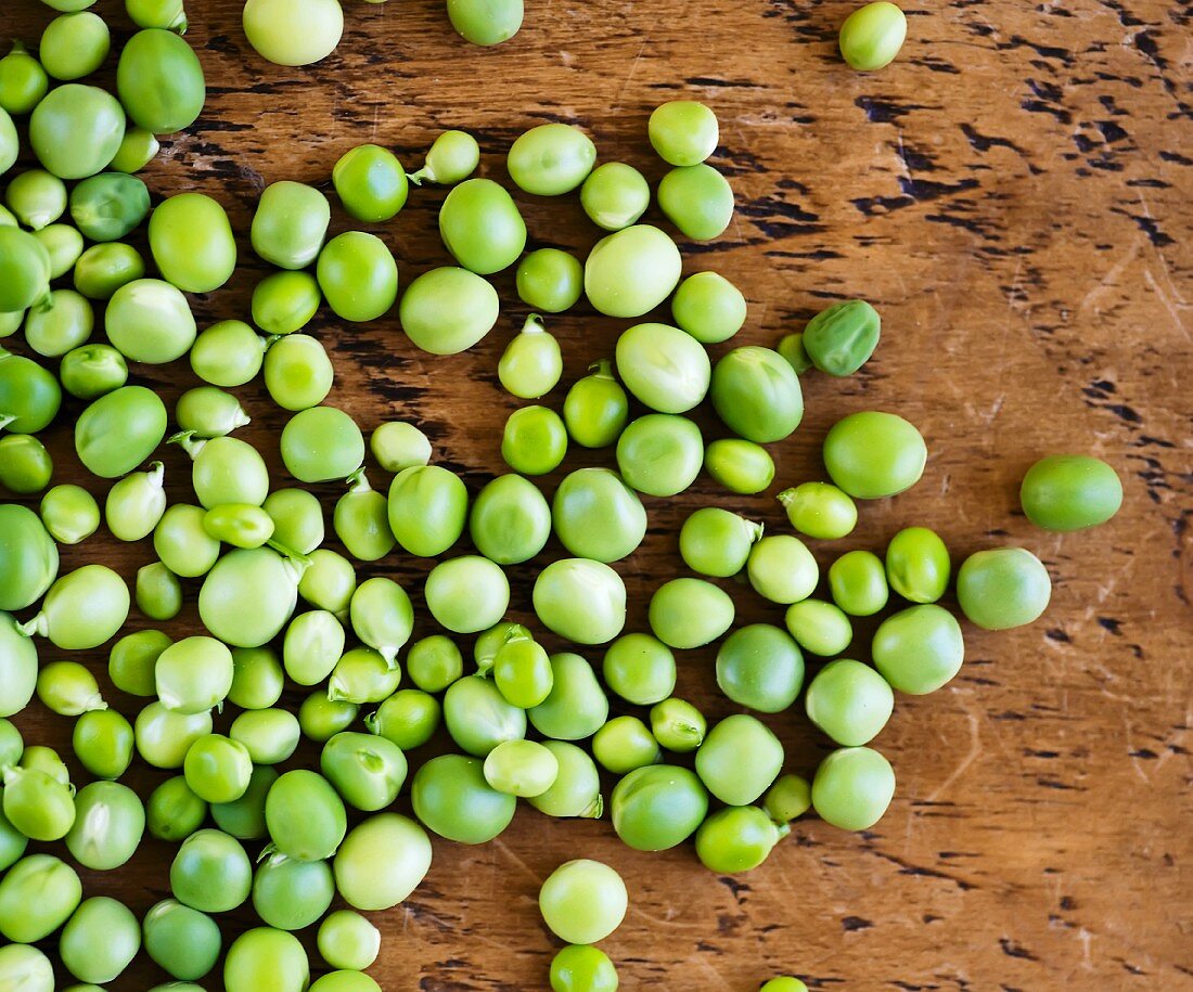 Fresh peas on a wooden surface