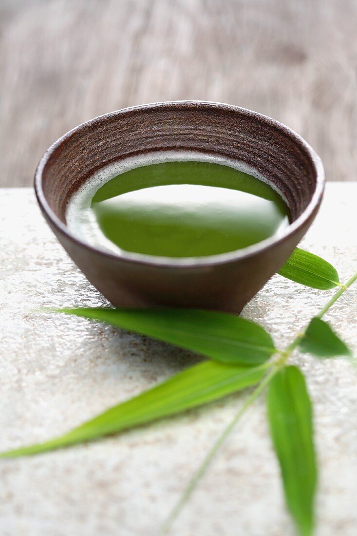 Close up of Japanese green Matcha tea and bamboo sprig