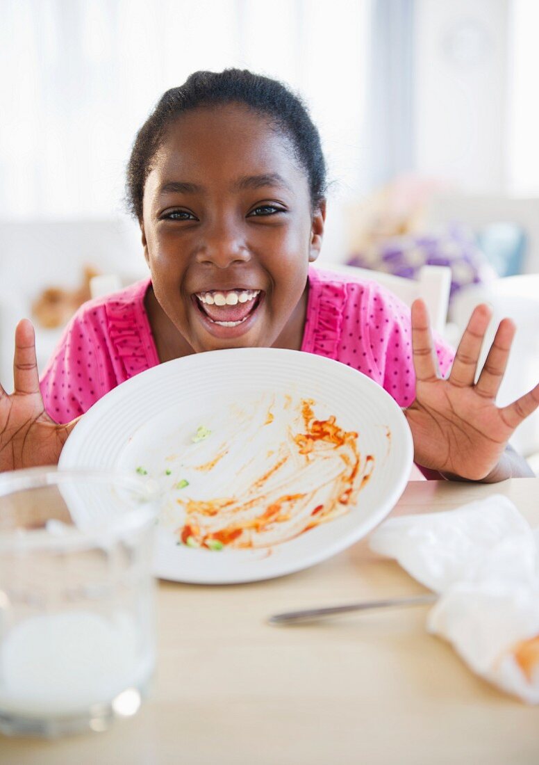 Black girl holding empty plate