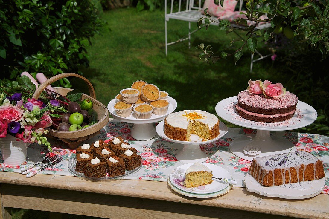 A cake buffet in a sunny garden