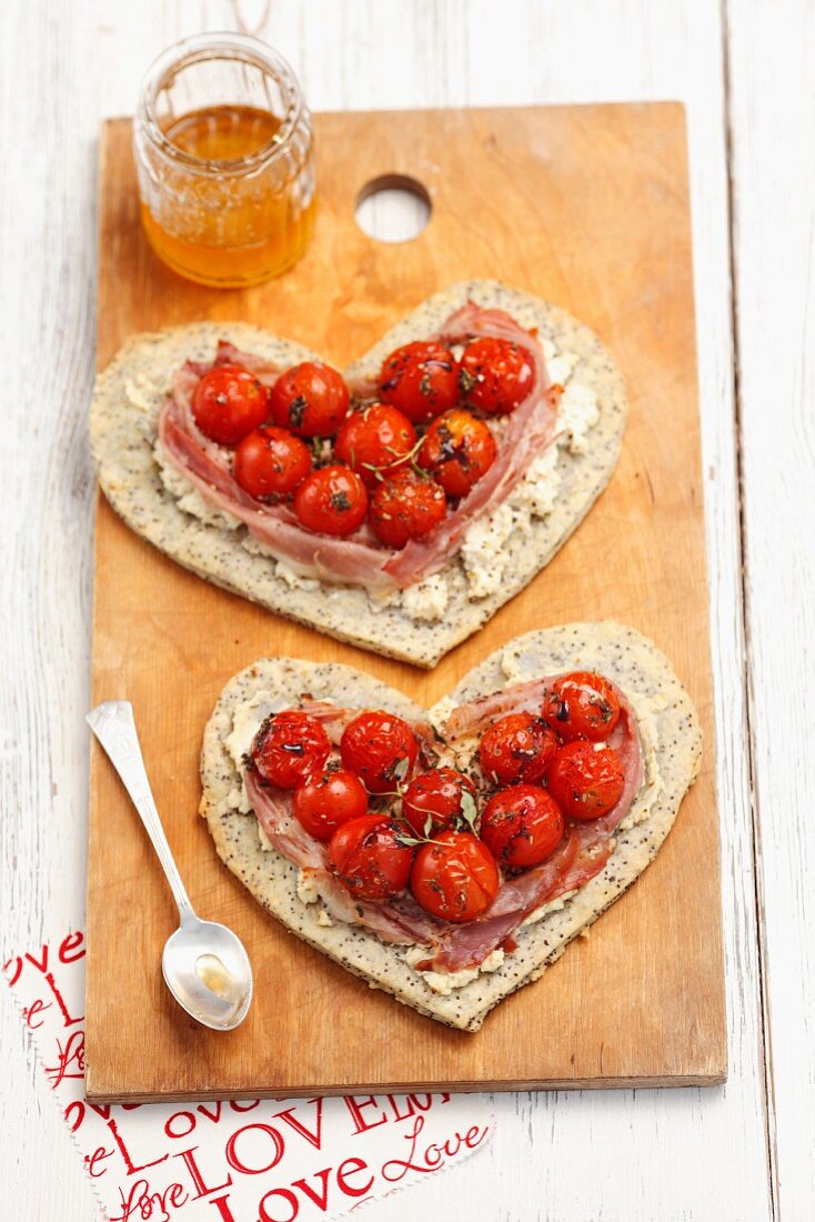 Heart-shaped poppyseed tarts with cherry tomatoes and prosciutto
