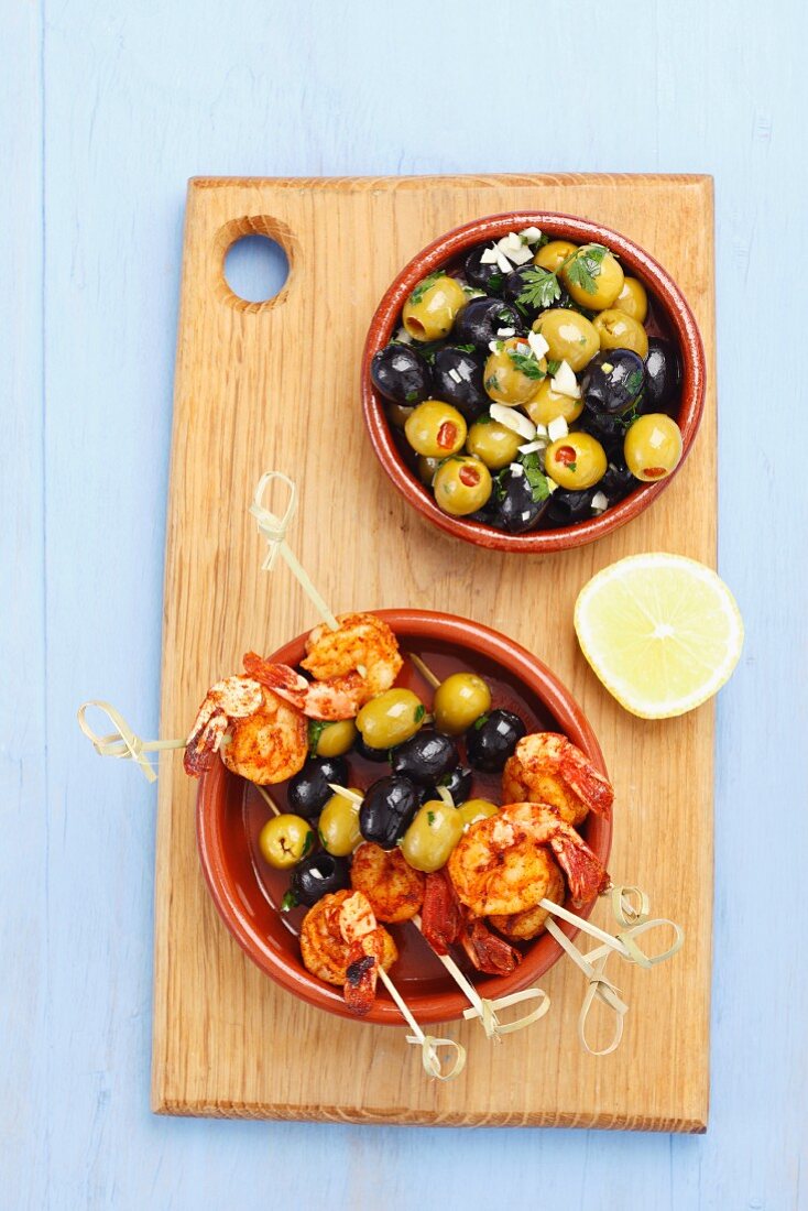 King prawn and olive skewers and marinated olives