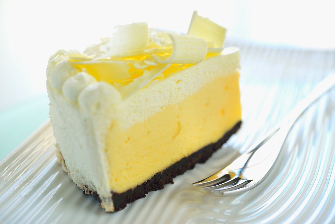 A slice of cream cake with white chocolate