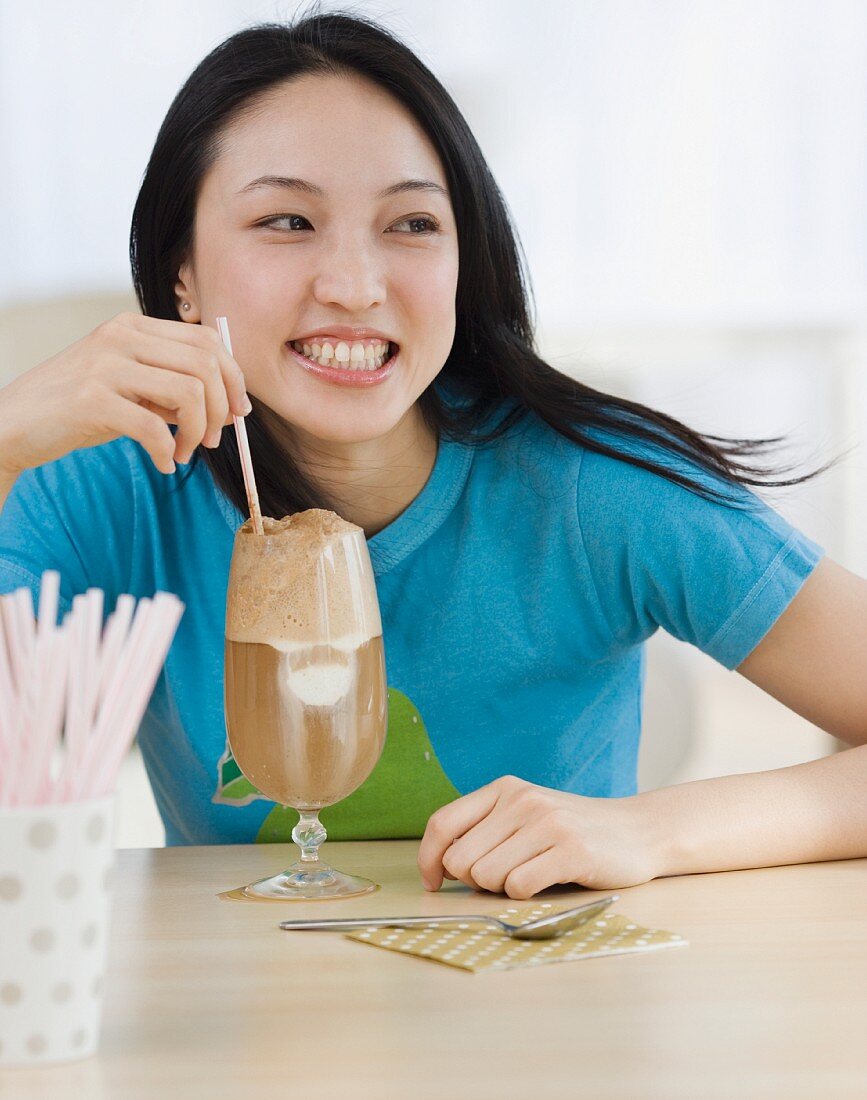 Asian woman drinking milkshake