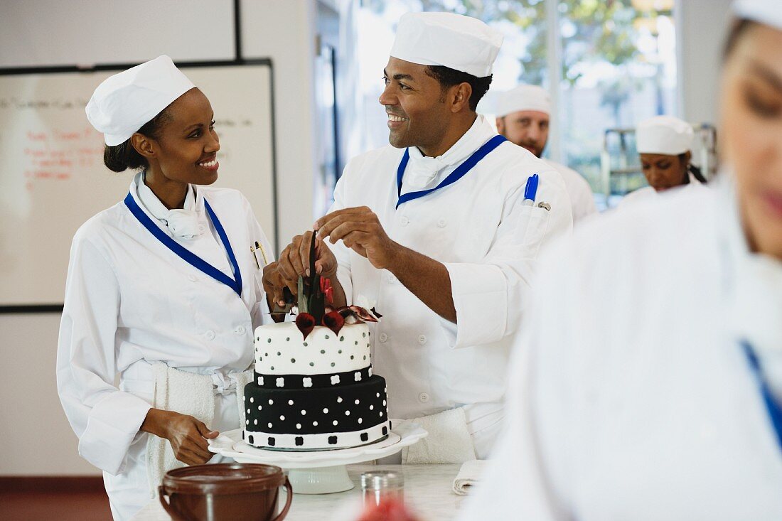 African pastry chefs decorating cakes