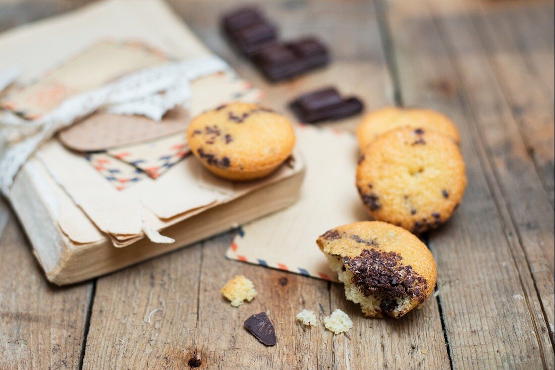 Financiers with chocolate, an old book and letters