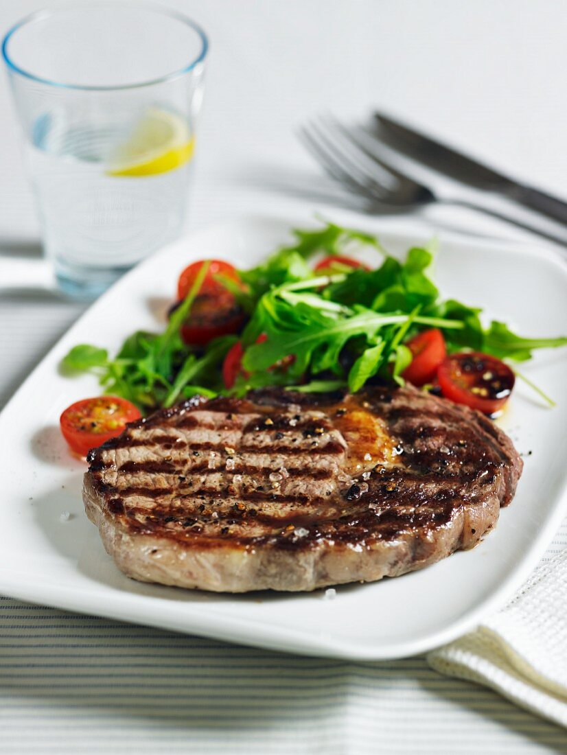 Beef steak with tomato and rocket salad