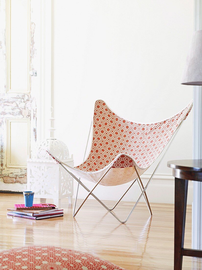 Butterfly chair with Moroccan-style pattern; floor cushion with same pattern in foreground