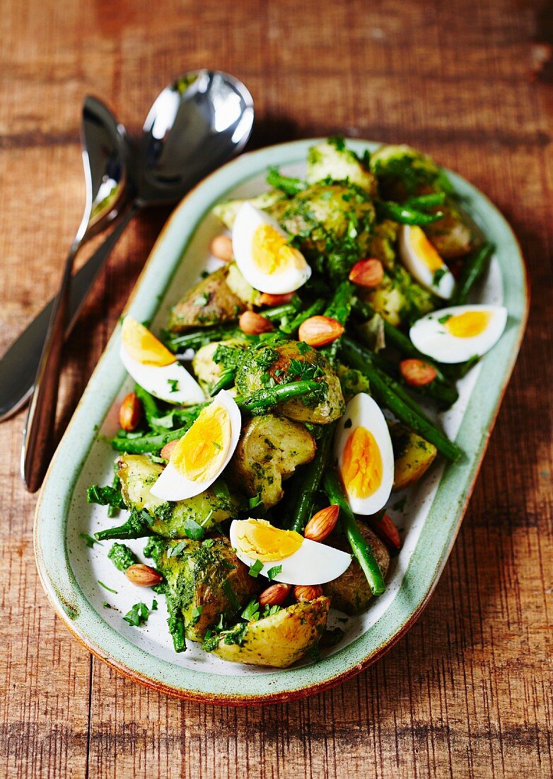 A salad of roast potatoes with green beans and egg