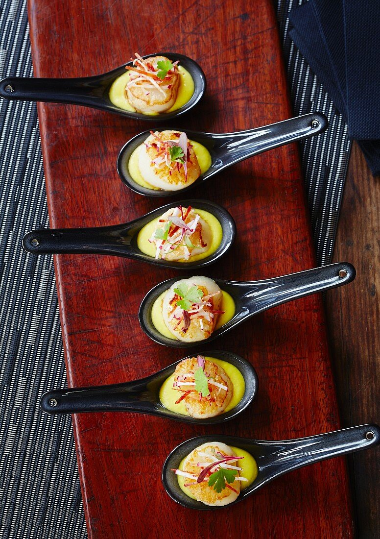 Taster spoons with scallops on sweetcorn pur
