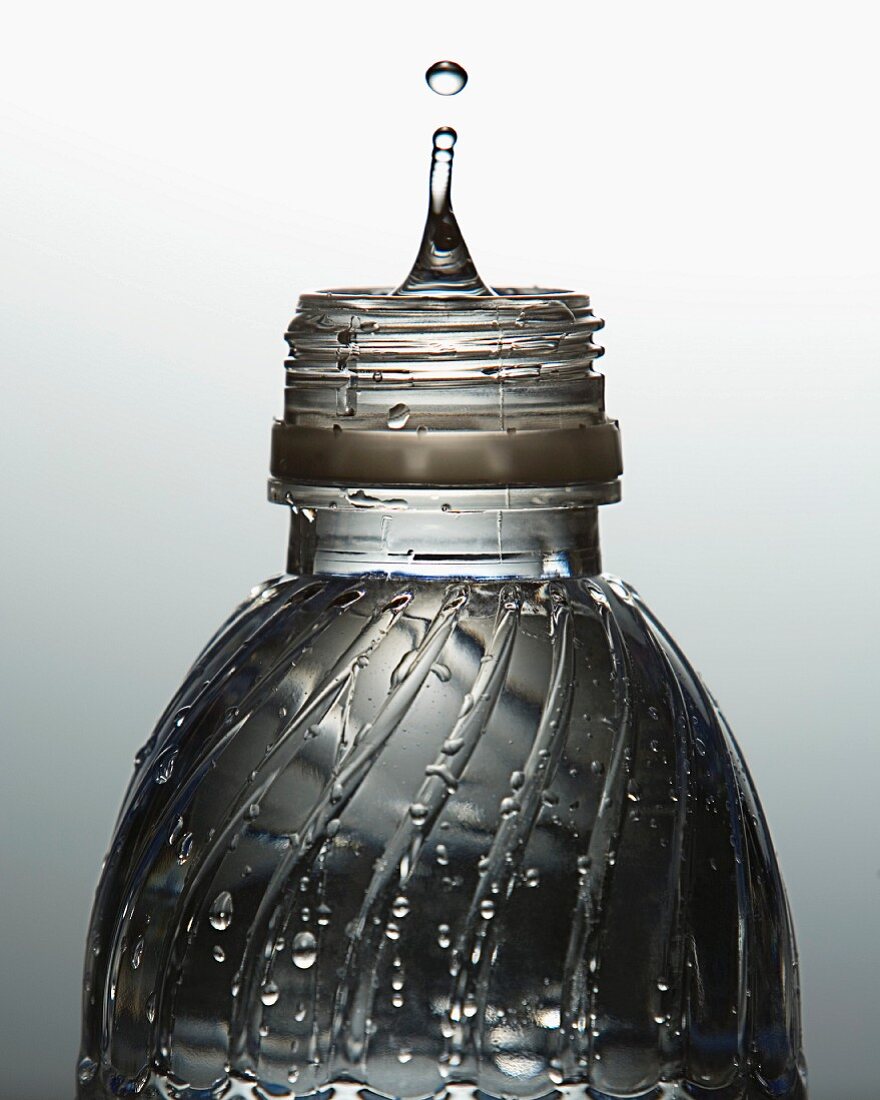 Bottle of water with drip rising from top