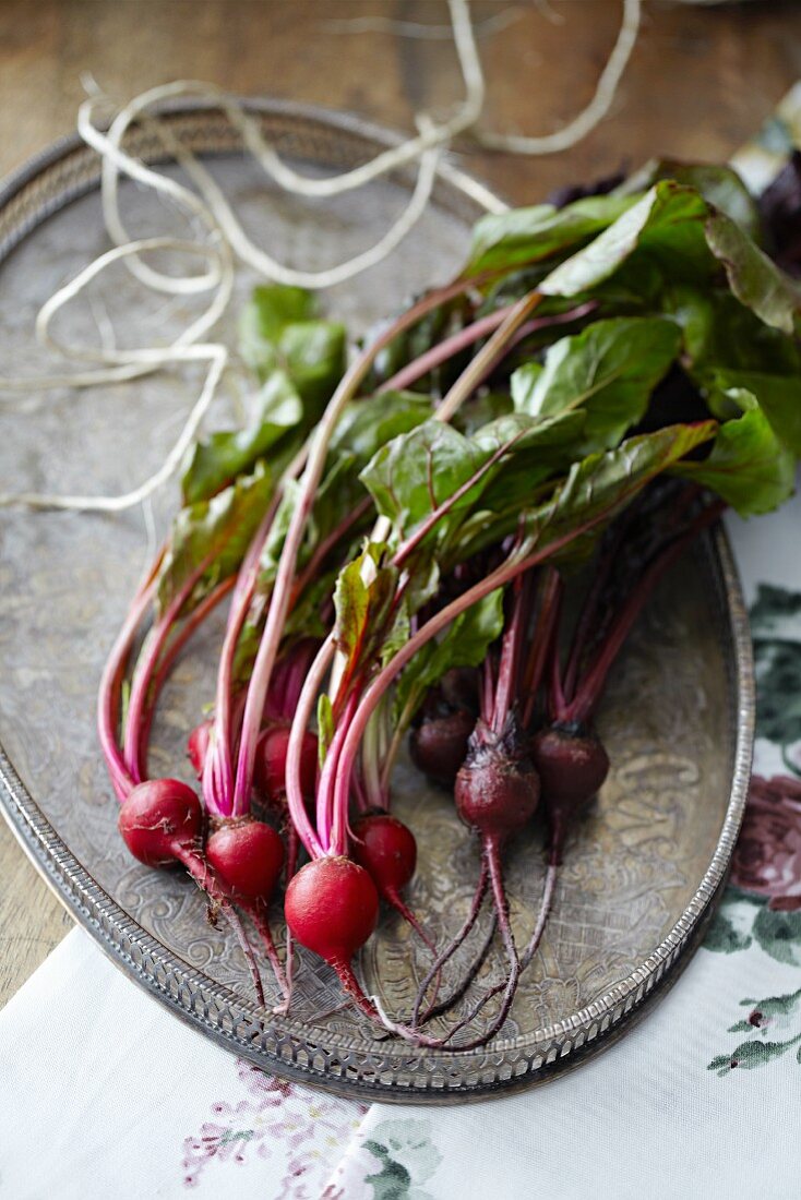 A bunch of beetroot on a metal tray