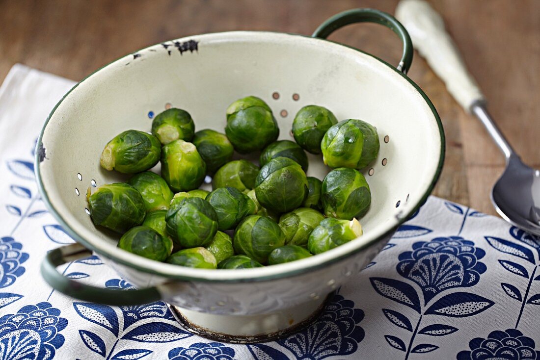 Steamed Brussels sprouts in a colander