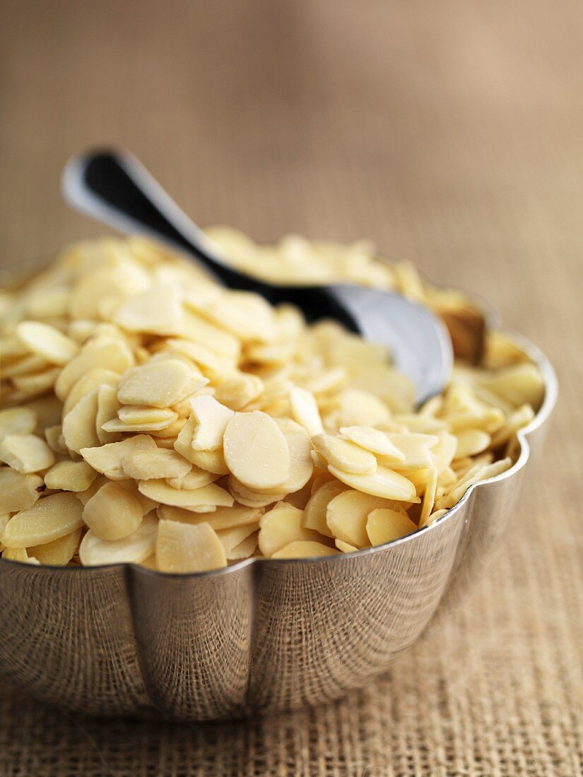 Flaked almonds in a metal bowl