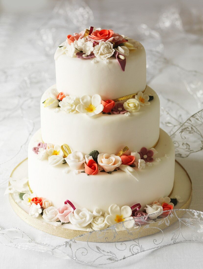 Three-tier wedding cake with fondant flowers