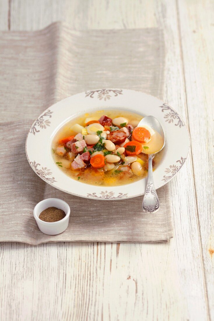 Vegetable soup with sausage, bacon and white beans