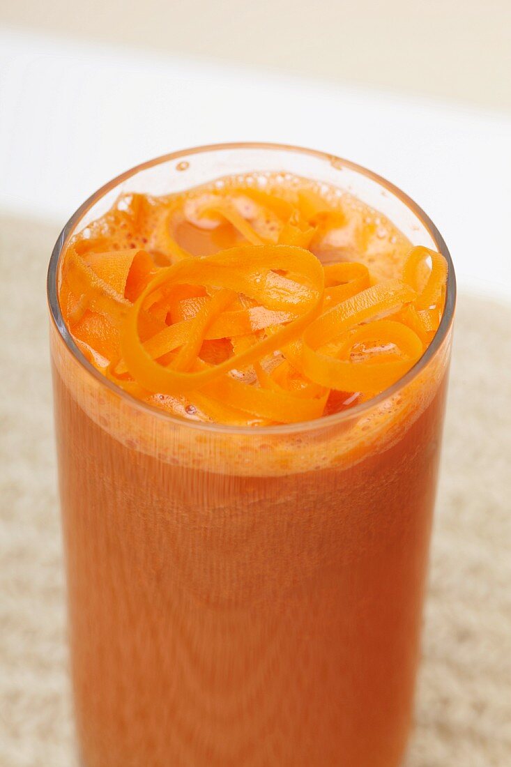 A Glass of Fresh Carrot Juice with Carrot Shavings