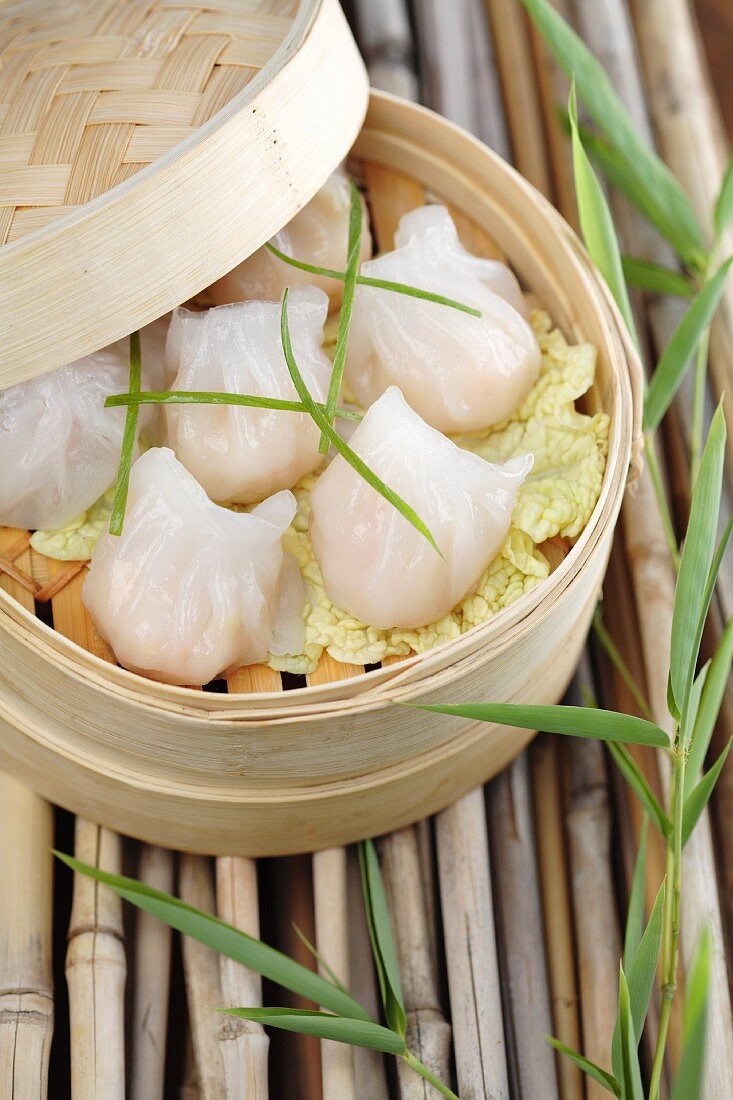 Close up of dim sum dumplings in bamboo basket