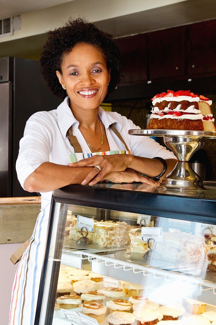 African American bakery owner standing in shop