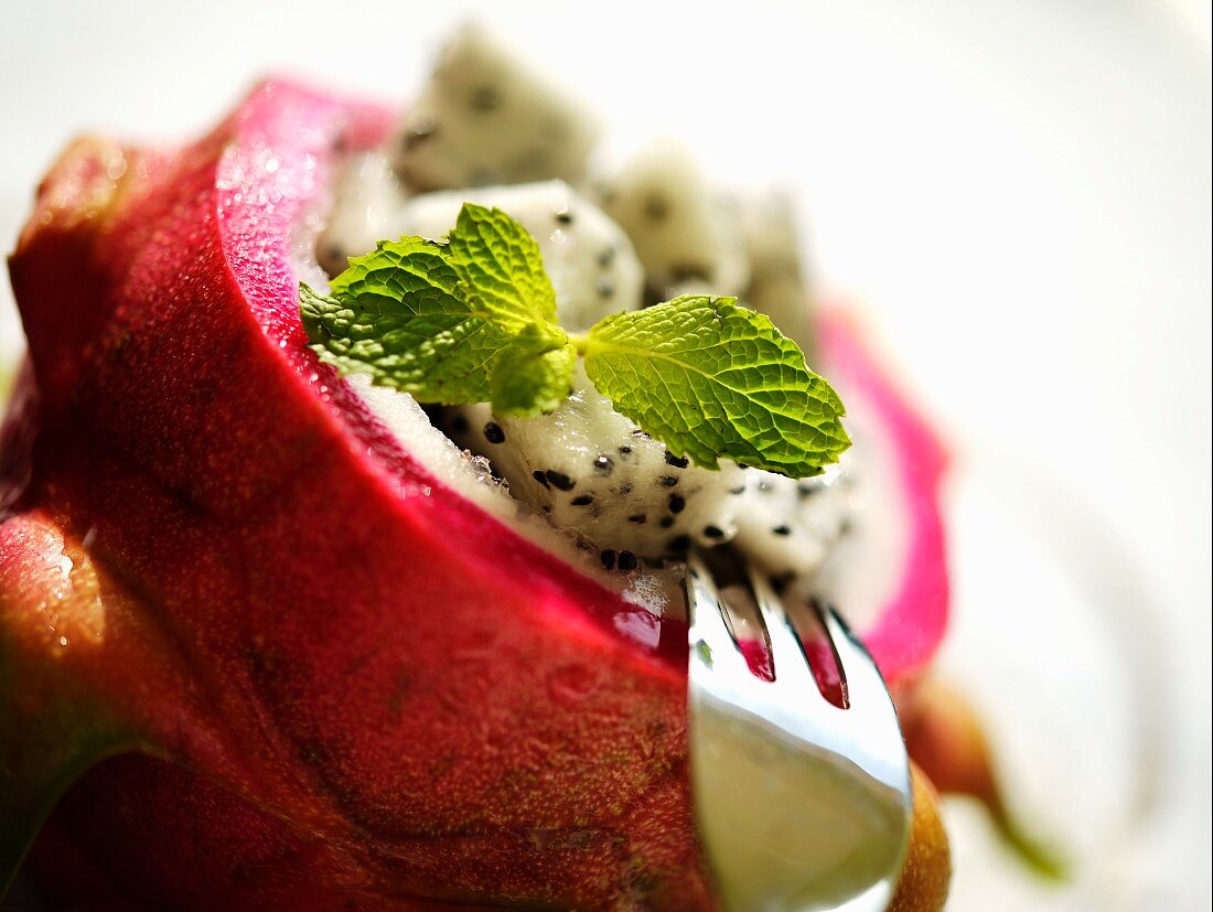 Dragon fruit salad with mint leaves (close-up)