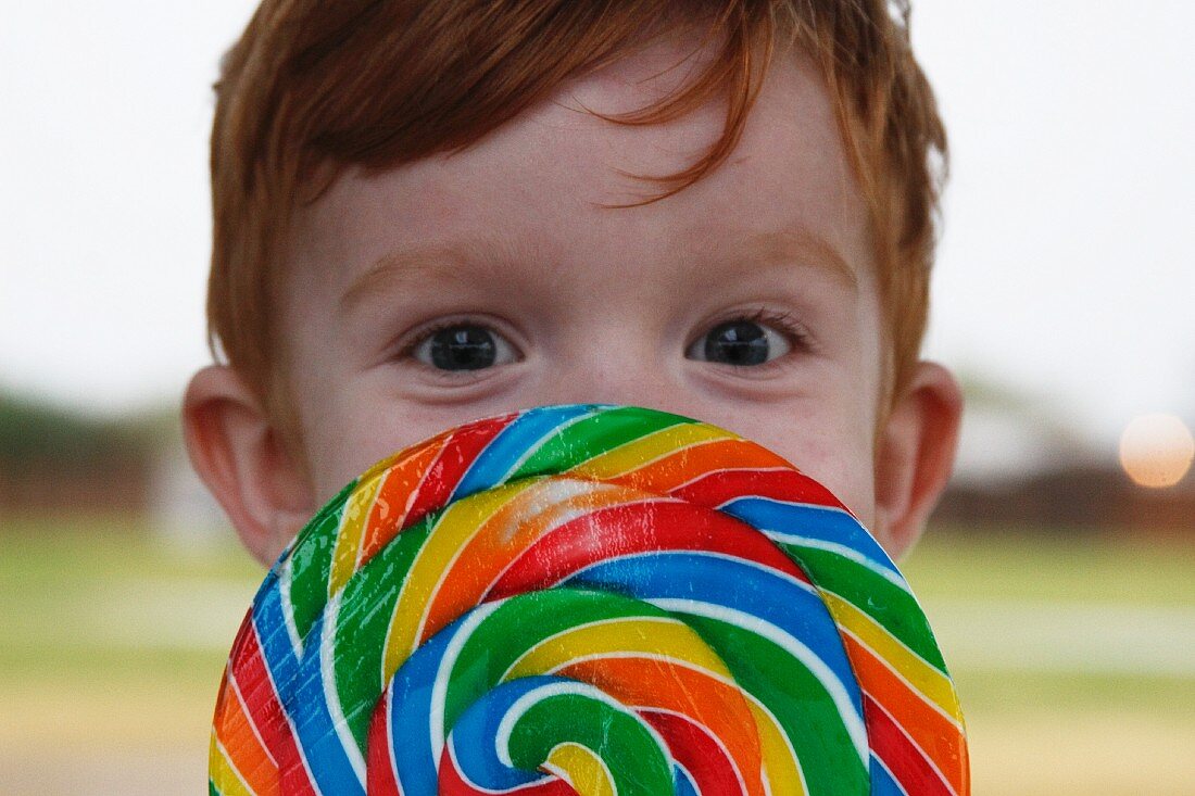 Boy Behind Rainbow Lollipop